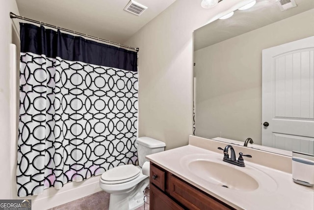 bathroom with tile patterned floors, vanity, toilet, and a shower with curtain