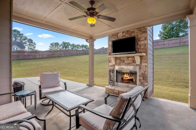 view of patio / terrace featuring an outdoor stone fireplace and ceiling fan