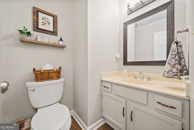 bathroom with vanity, hardwood / wood-style flooring, and toilet