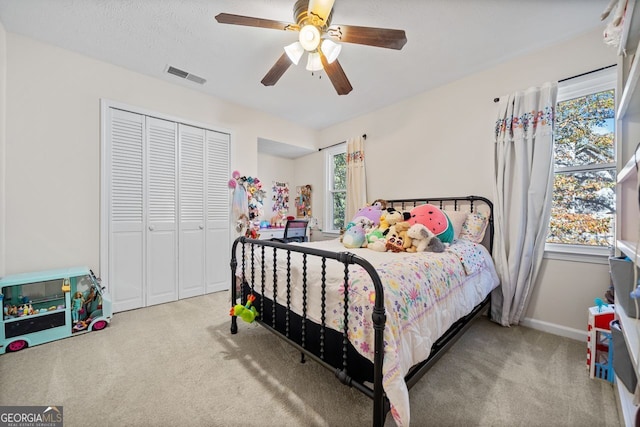 bedroom featuring light carpet, a closet, and ceiling fan