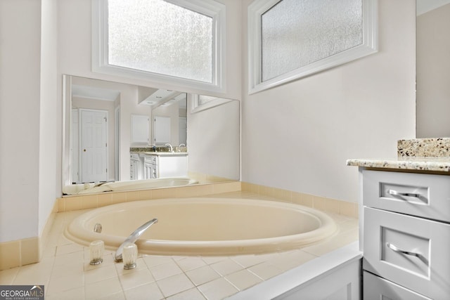 bathroom with vanity and a relaxing tiled tub