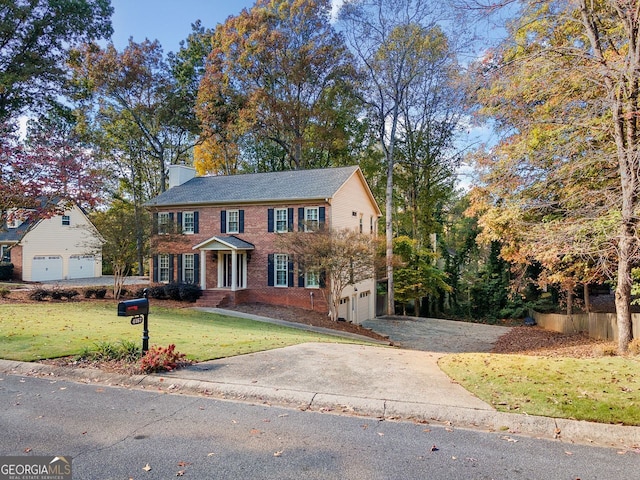 colonial home featuring a front yard