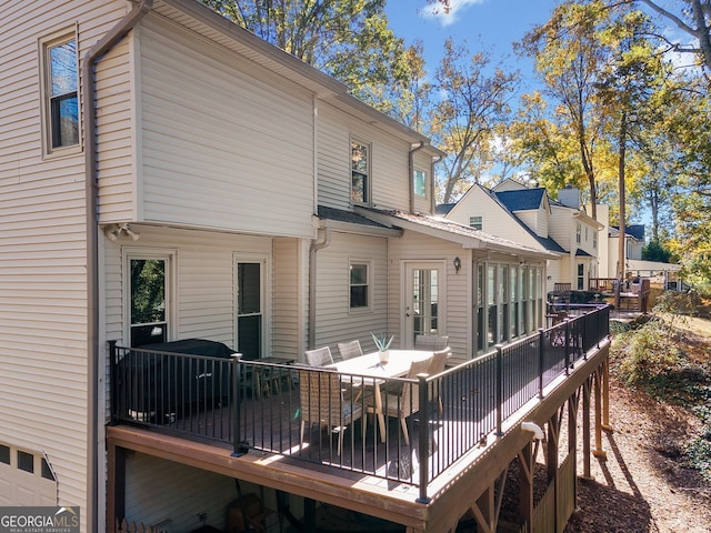 back of property with a wooden deck