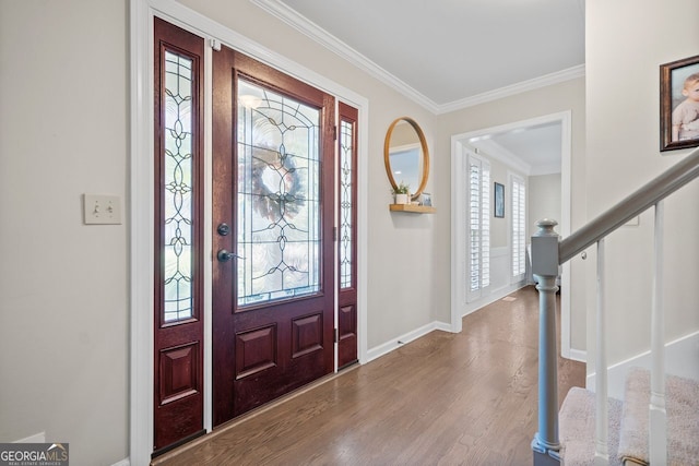 foyer with plenty of natural light, light wood-type flooring, and ornamental molding