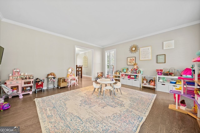 playroom with crown molding and dark hardwood / wood-style flooring