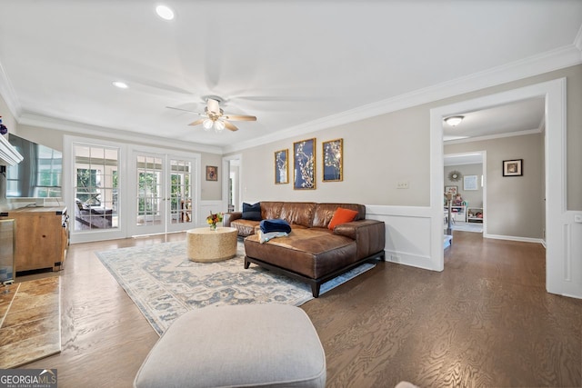 living room with ceiling fan, dark hardwood / wood-style flooring, and ornamental molding