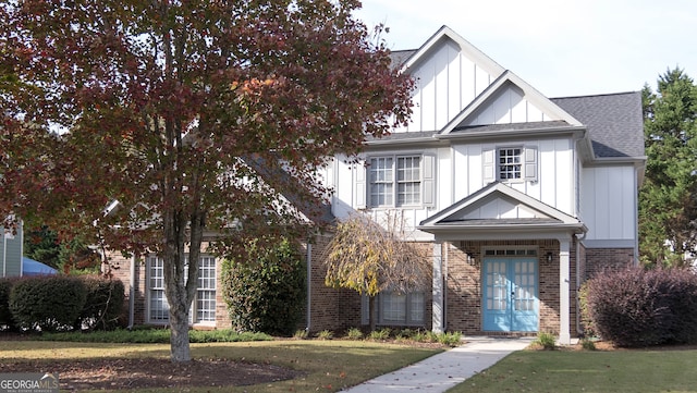 view of front of home with french doors and a front yard