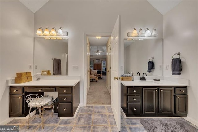 bathroom with tile patterned floors, ceiling fan, vanity, and vaulted ceiling