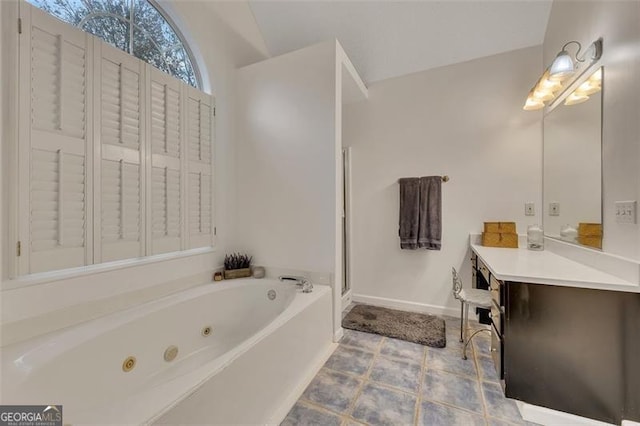 bathroom with tile patterned floors, vanity, shower with separate bathtub, and vaulted ceiling