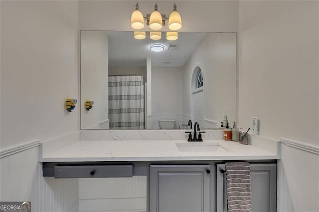 bathroom featuring vanity, toilet, and walk in shower