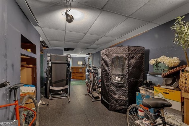 exercise room with a drop ceiling