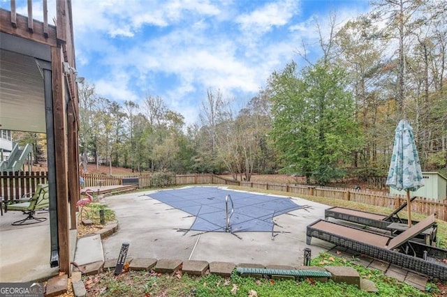 view of swimming pool featuring a patio area