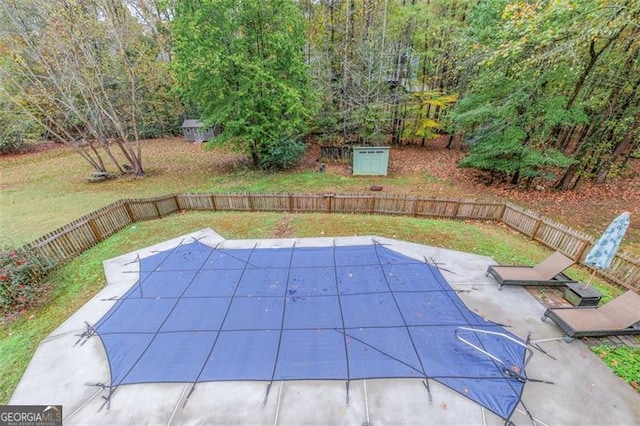 view of pool featuring a lawn