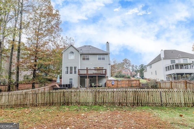 back of property with a wooden deck