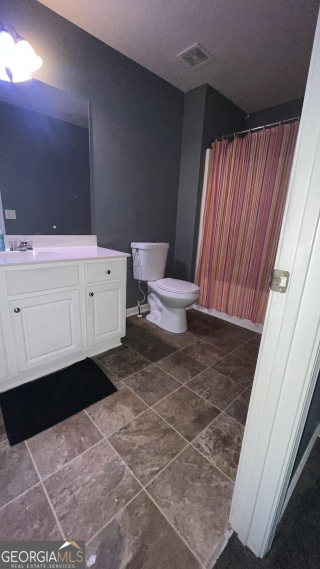 bathroom featuring toilet and sink