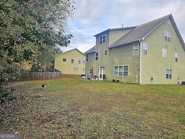 rear view of property with a lawn