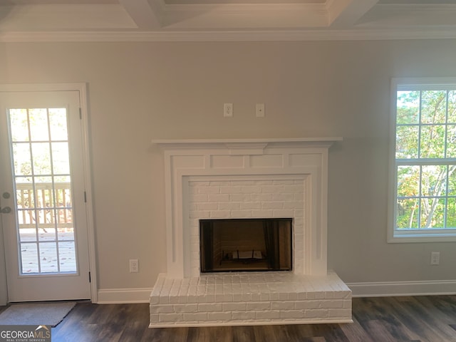 room details featuring beamed ceiling, hardwood / wood-style flooring, a brick fireplace, and crown molding