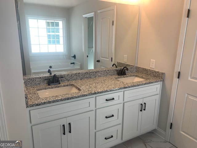 bathroom featuring a tub to relax in and vanity