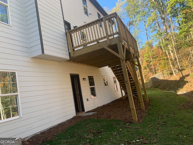 view of side of home with a lawn and a deck