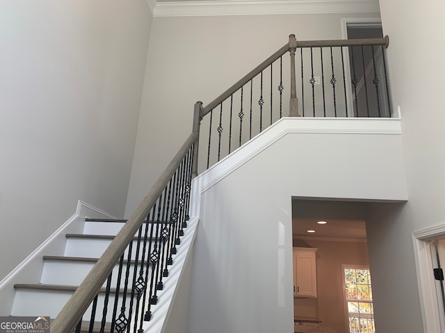 stairway featuring crown molding