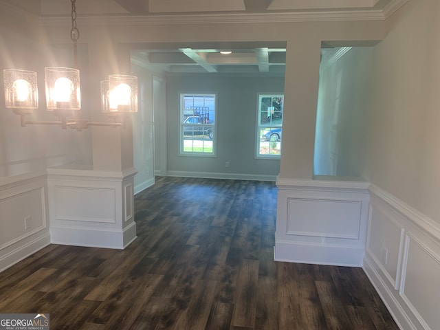 spare room with beamed ceiling, dark hardwood / wood-style floors, crown molding, and coffered ceiling