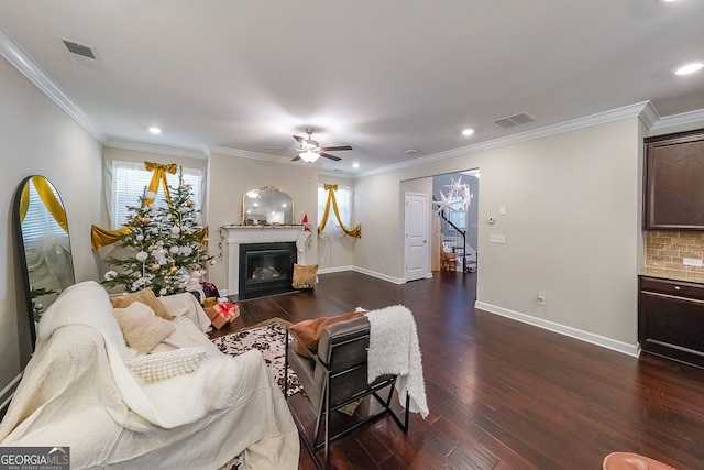 living room with dark hardwood / wood-style flooring, ceiling fan, and ornamental molding