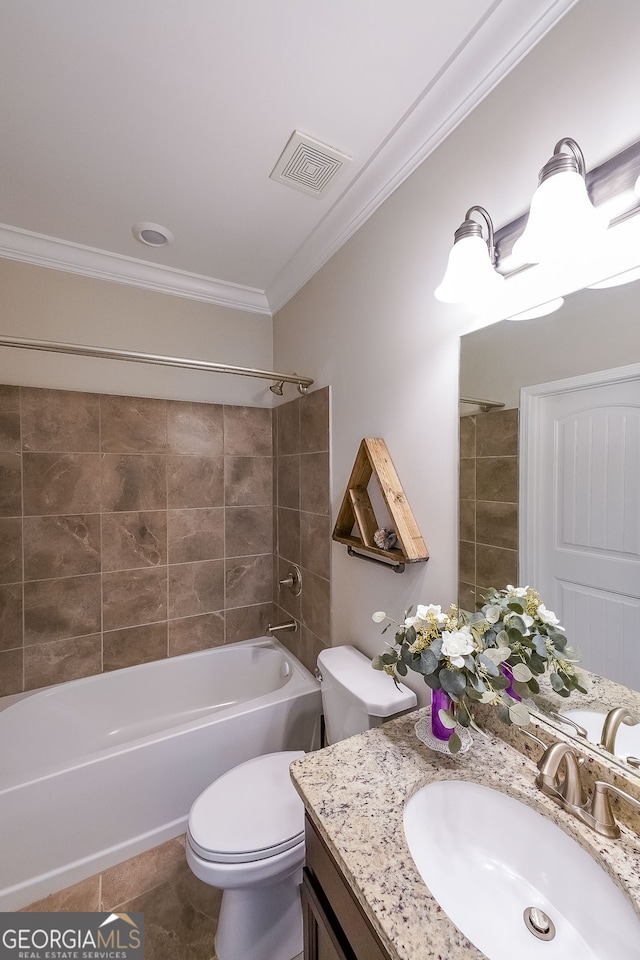 full bathroom featuring vanity, crown molding, tile patterned flooring, toilet, and tiled shower / bath