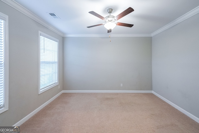 carpeted empty room with ceiling fan and ornamental molding