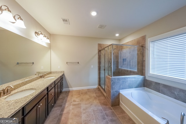 bathroom featuring tile patterned floors, plus walk in shower, and vanity