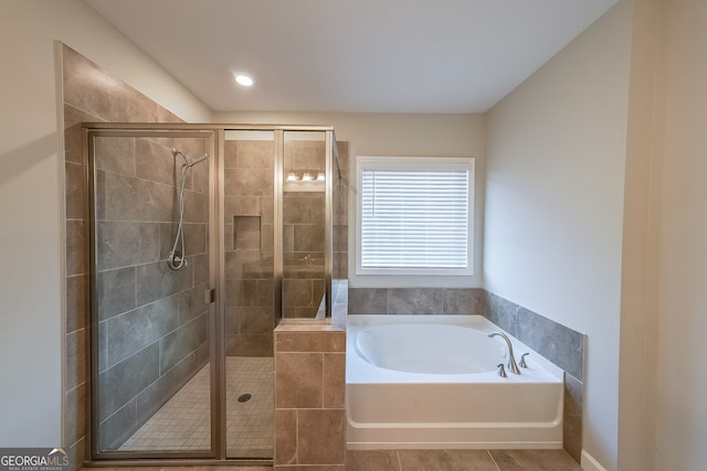 bathroom with tile patterned flooring and shower with separate bathtub