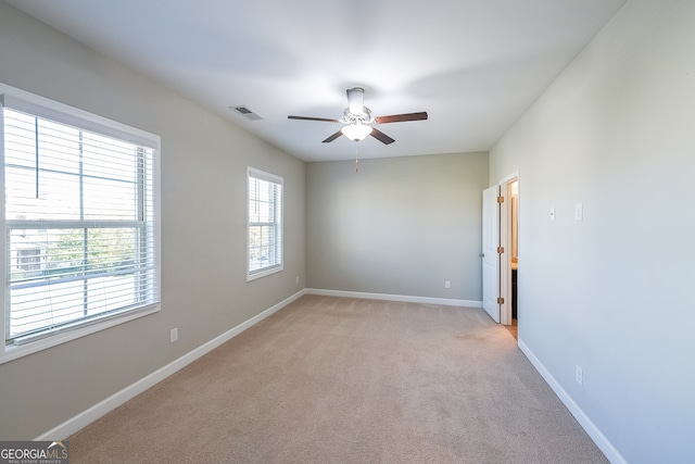 unfurnished room with ceiling fan and light colored carpet