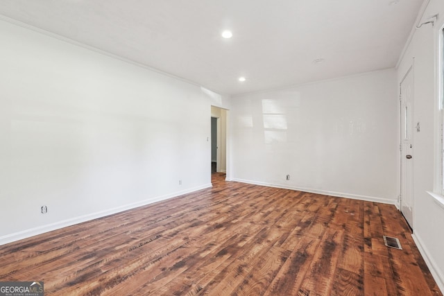 unfurnished room with dark wood-type flooring and ornamental molding