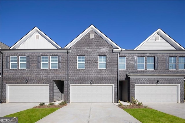 224 Epping St Unit 7, Stockbridge, GA 30281 - view of property with an attached garage, concrete driveway, and brick siding