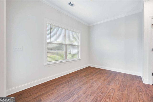 empty room with crown molding and dark wood-type flooring