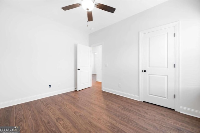 unfurnished bedroom with ceiling fan and dark hardwood / wood-style flooring