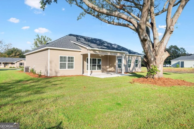 rear view of house with a patio, ceiling fan, a lawn, and central air condition unit