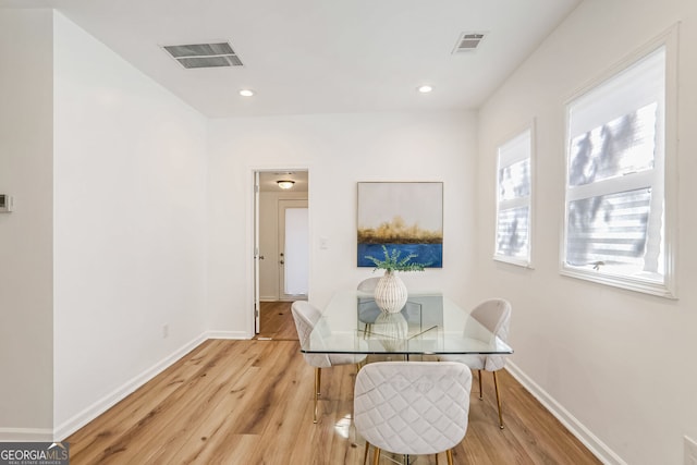 dining area featuring light hardwood / wood-style flooring and a healthy amount of sunlight