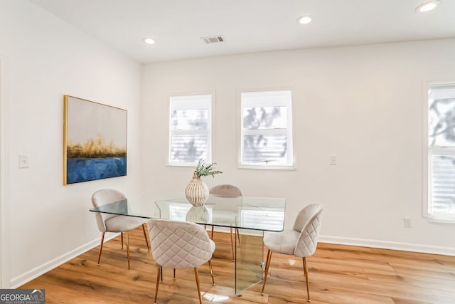 dining area with light hardwood / wood-style flooring and a healthy amount of sunlight