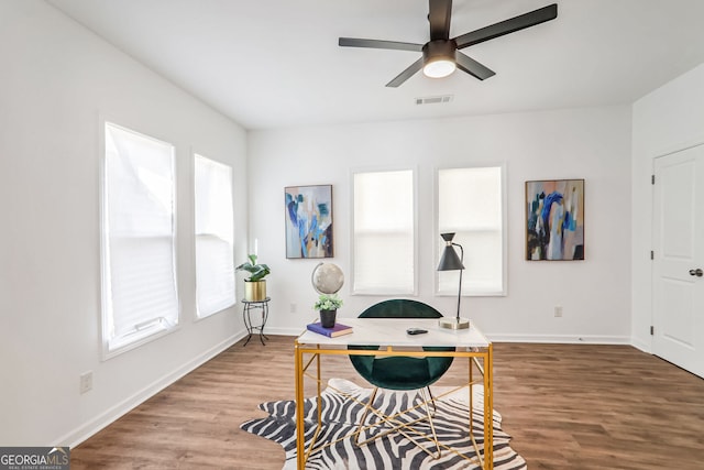 office with ceiling fan and hardwood / wood-style flooring