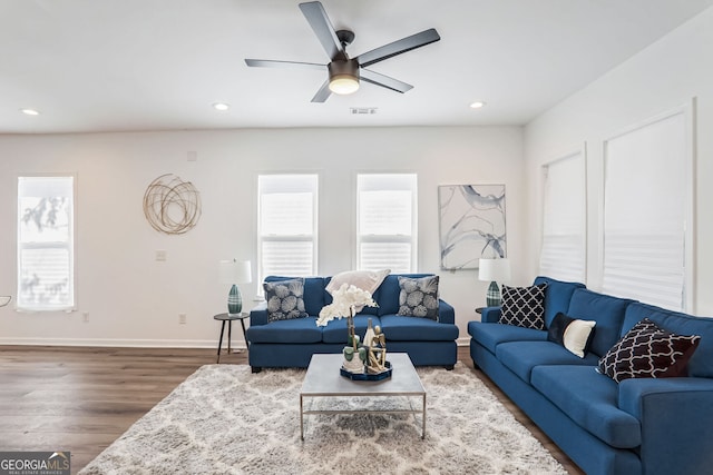 living room featuring hardwood / wood-style floors and ceiling fan