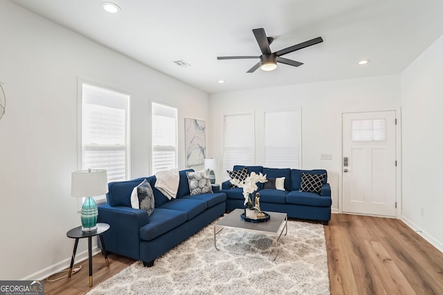 living room featuring ceiling fan and hardwood / wood-style flooring