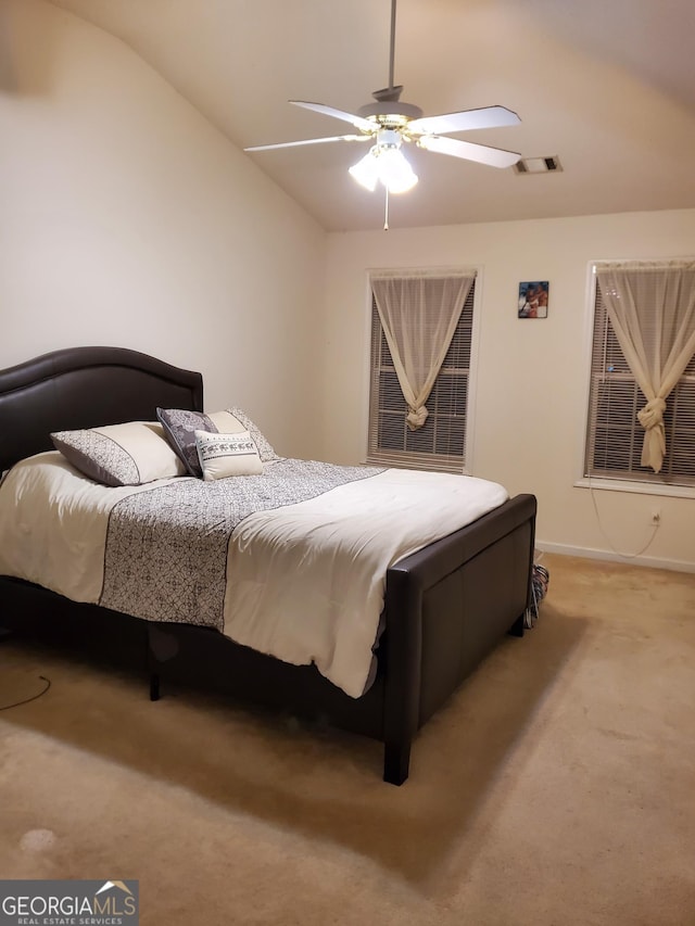 carpeted bedroom with ceiling fan and lofted ceiling