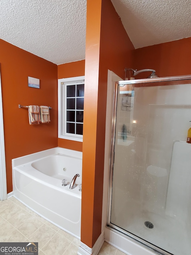 bathroom with independent shower and bath, tile patterned flooring, and a textured ceiling