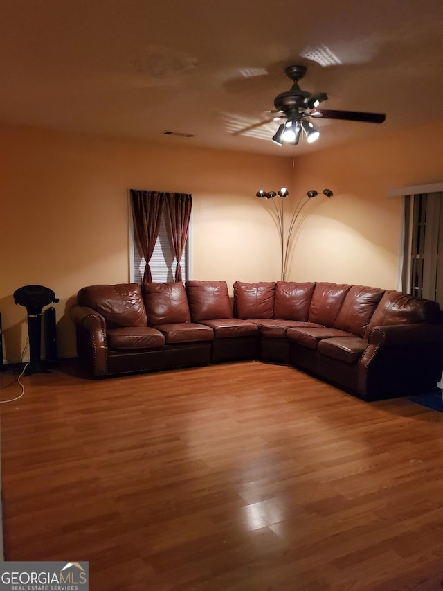 unfurnished living room with hardwood / wood-style flooring and ceiling fan