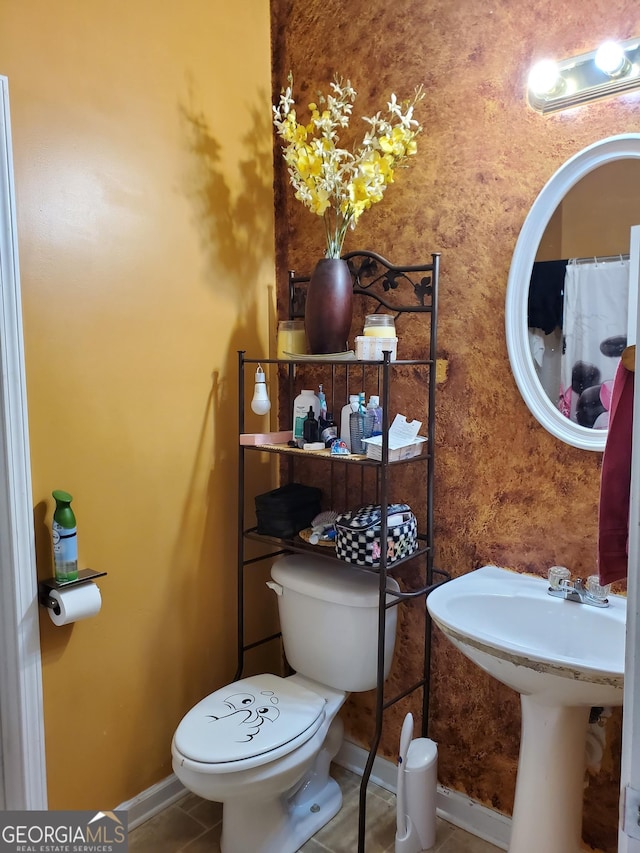 bathroom with sink, tile patterned floors, and toilet