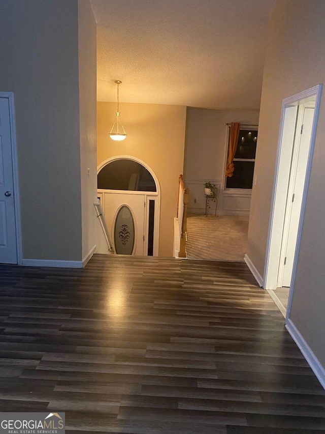 corridor featuring dark hardwood / wood-style floors