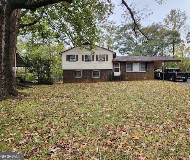 tri-level home featuring a carport and a front yard