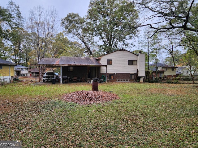 back of property featuring a carport and a lawn