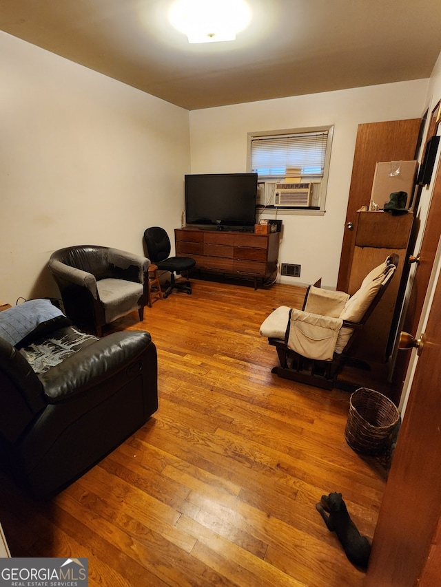 living room featuring cooling unit and light wood-type flooring