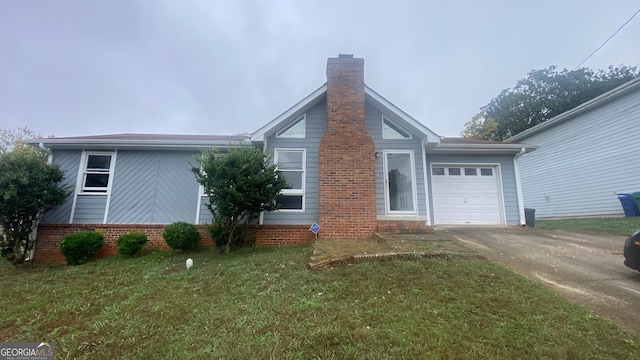 exterior space featuring a lawn and a garage